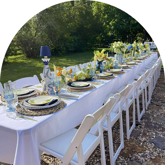 Long table with white chairs outside